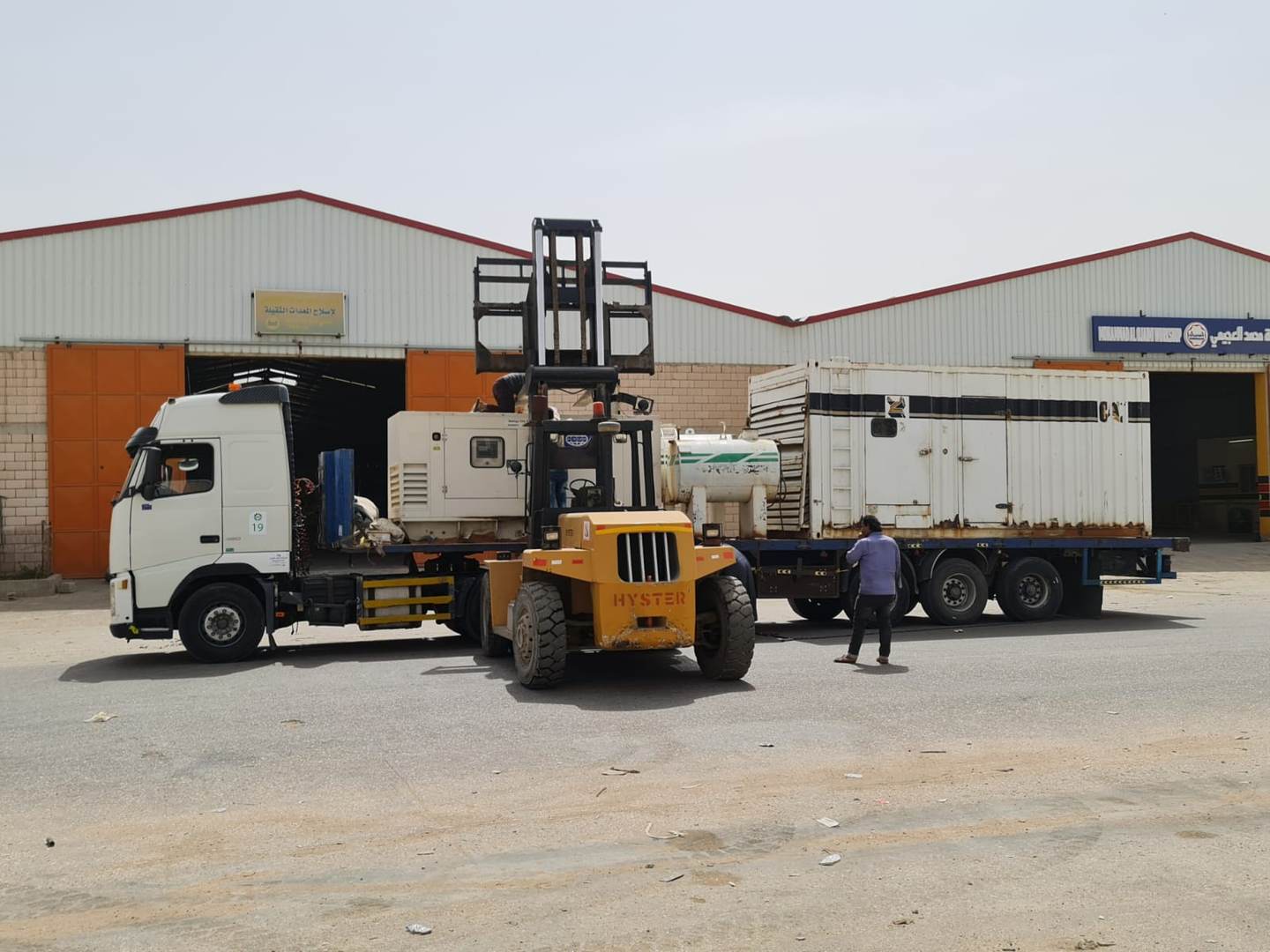 White Dream forklift handling generator material on site