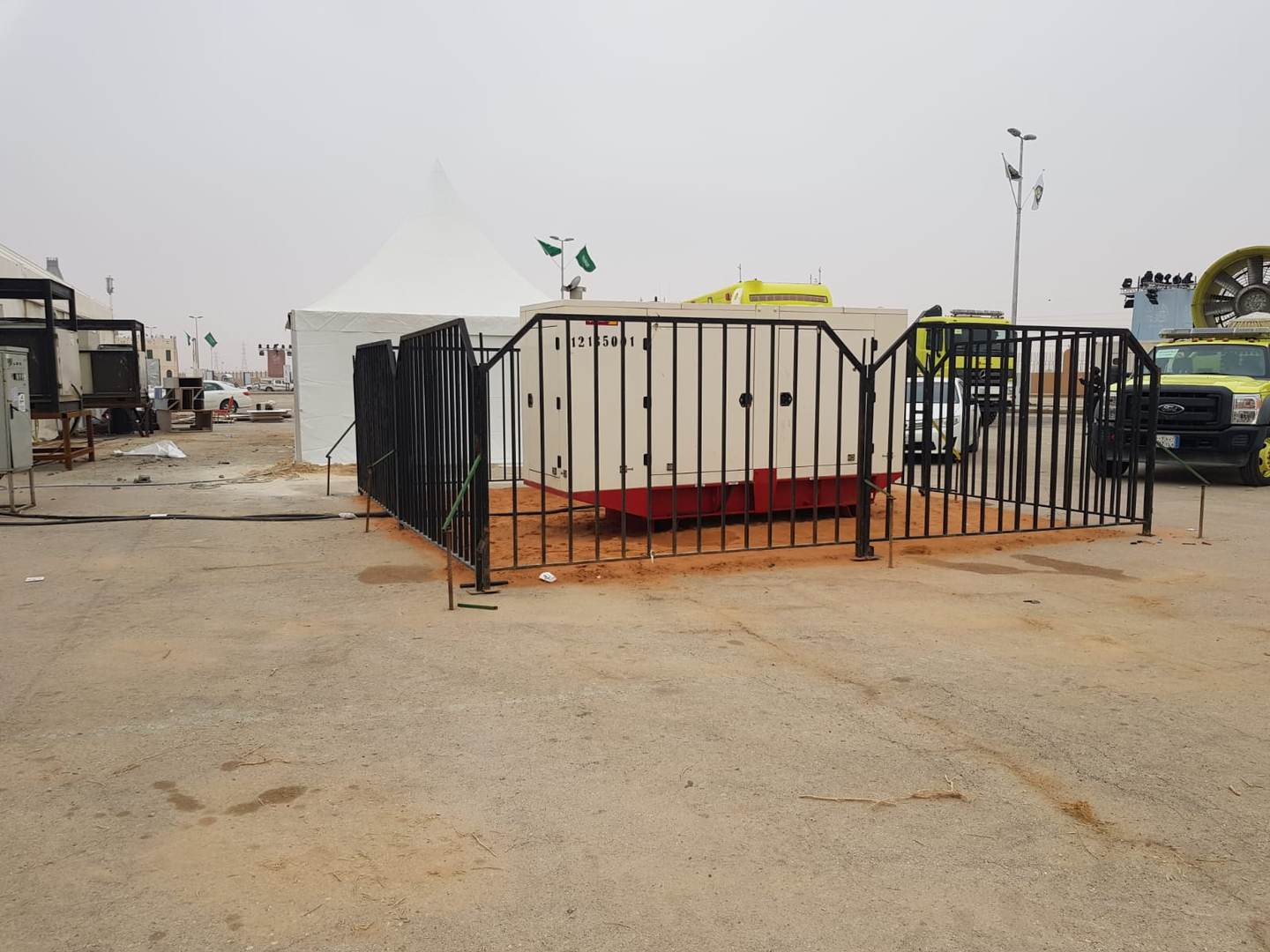 Generator secured behind safety barrier at event site