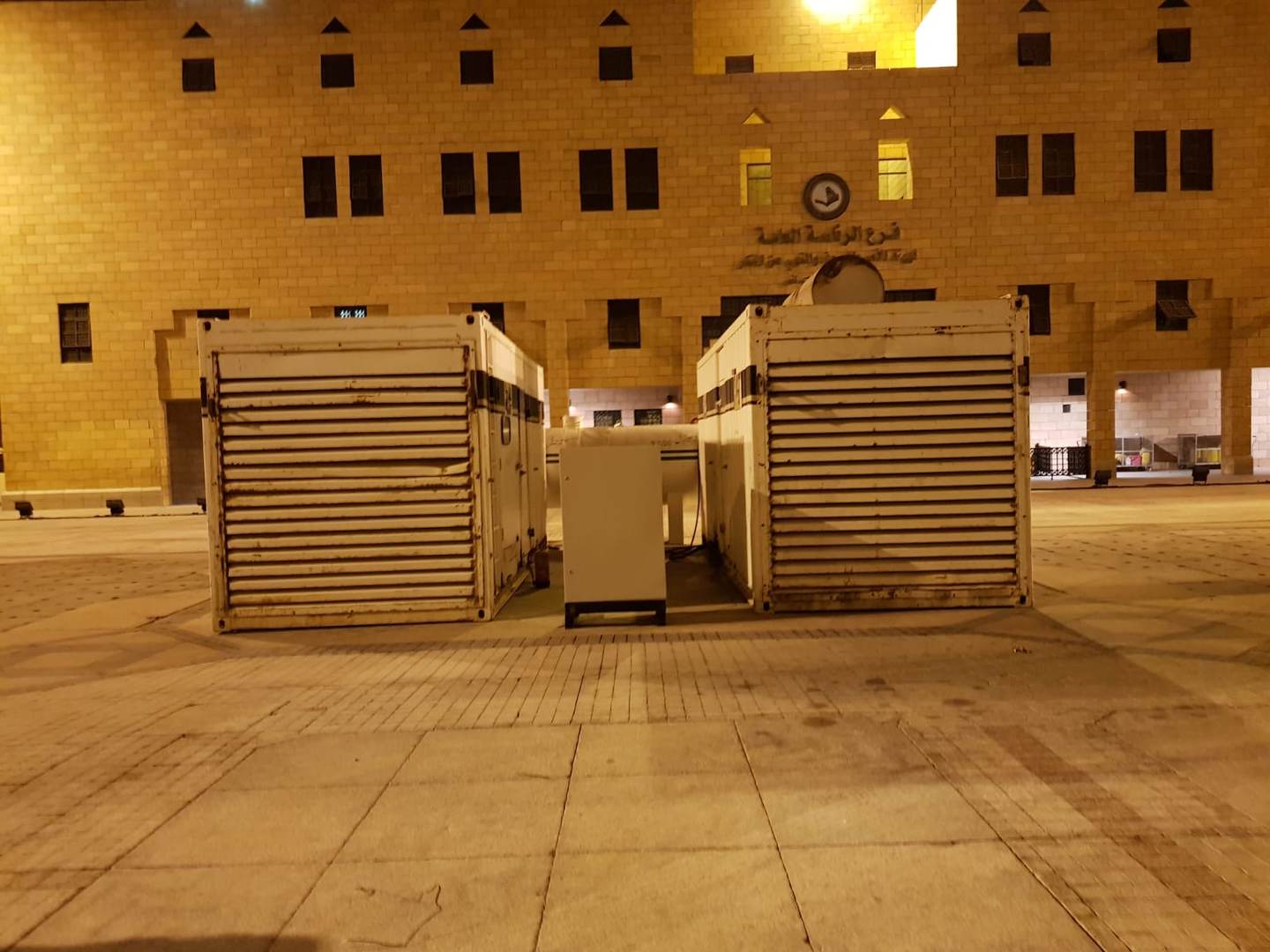Generator containers installed at government building facade at night