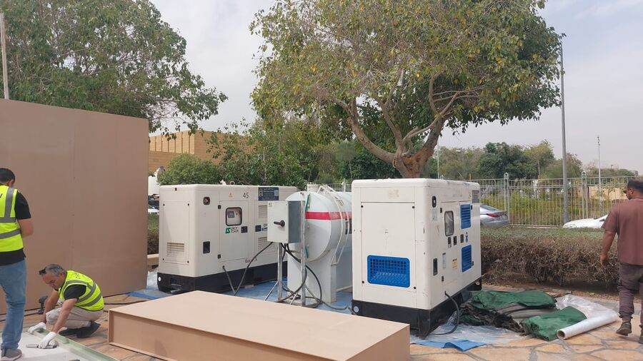 White Dream generators and fuel tank installed at a landscaped commercial site