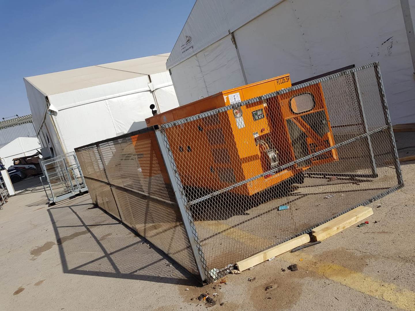 White Dream diesel generator secured on site in a fenced enclosure