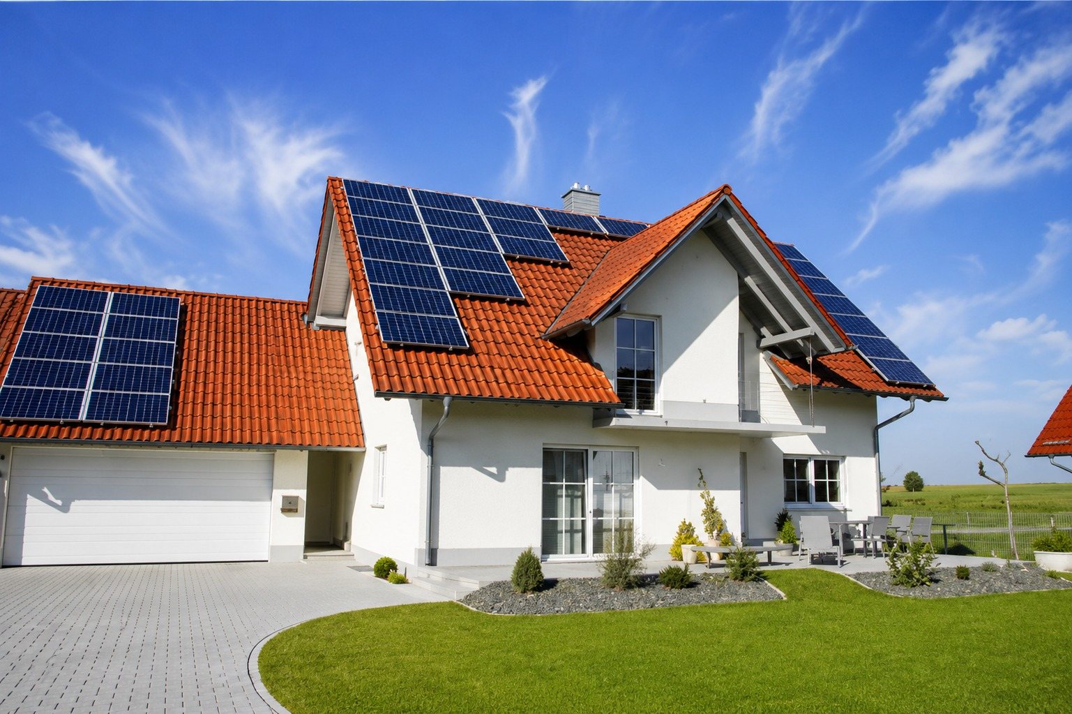 White Dream technician commissioning a solar inverter and battery system beside a solar panel array in Saudi Arabia