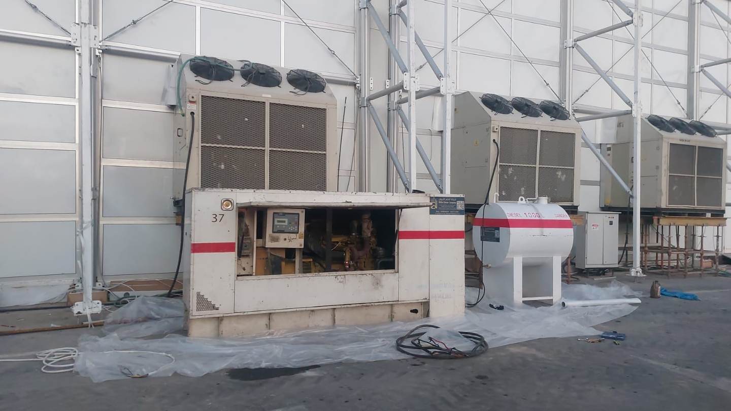 White Dream electrical installation crew connecting generator, fuel tank and cabling on site in Saudi Arabia