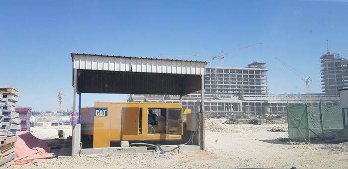 White Dream CAT generator sheltered on an active construction site
