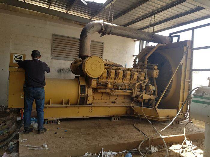 White Dream CAT generator serviced inside an industrial facility